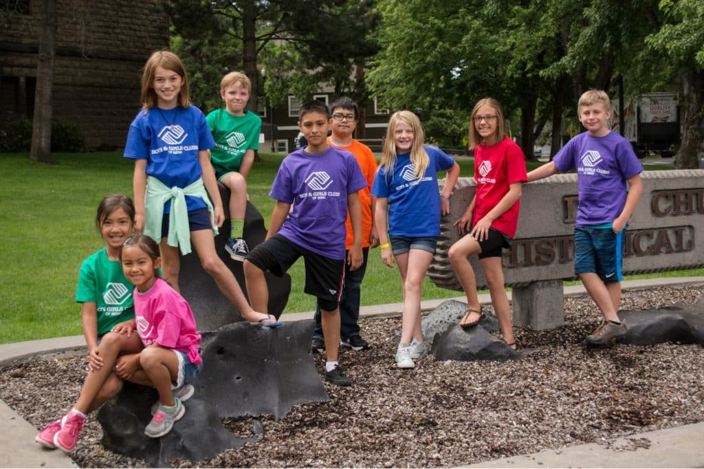 a group of kids from the Boys & Girls Club posing for a photo outside