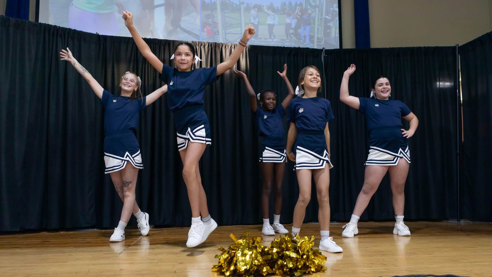 a group of cheerleaders on a stage