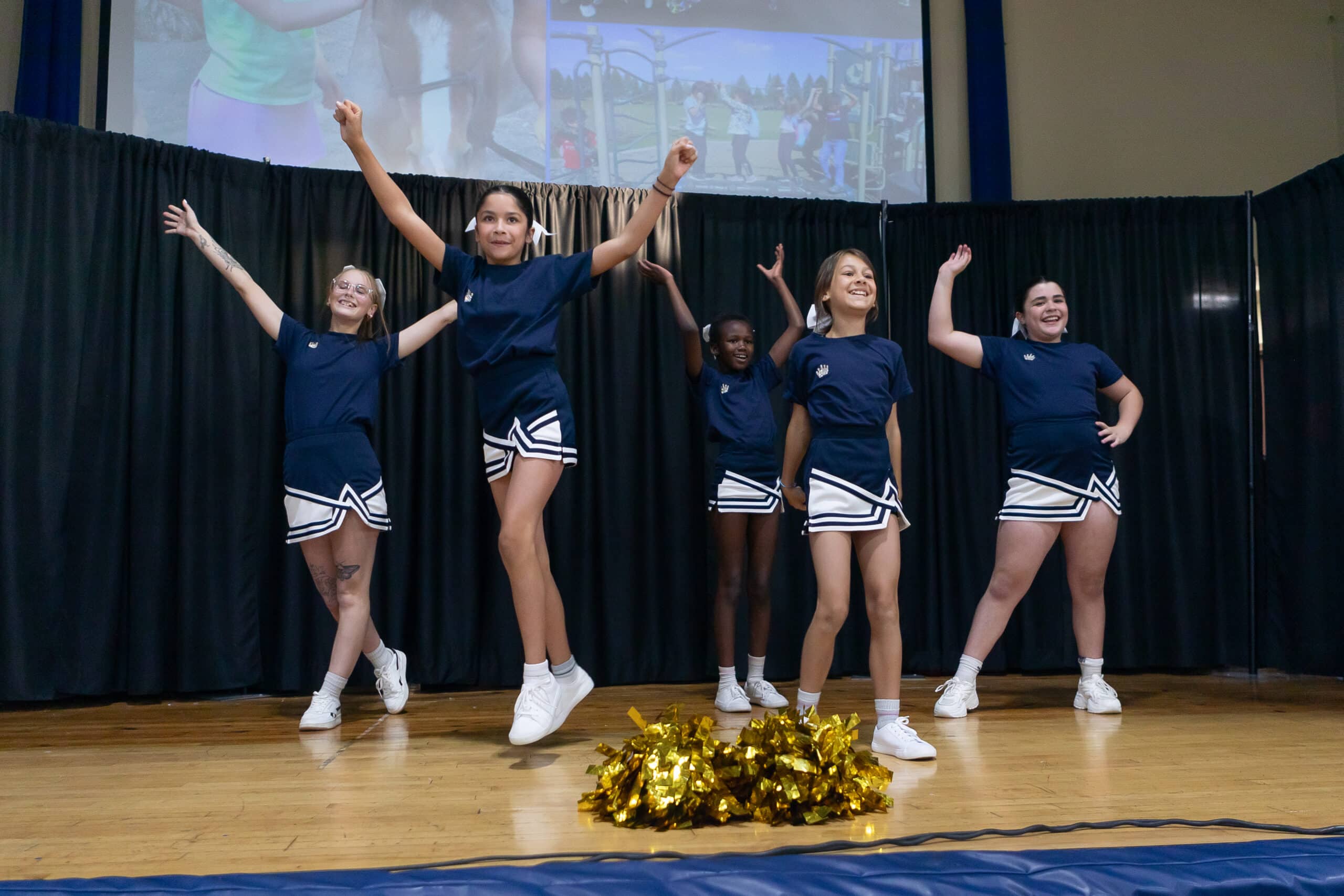 a group of cheerleaders on a stage