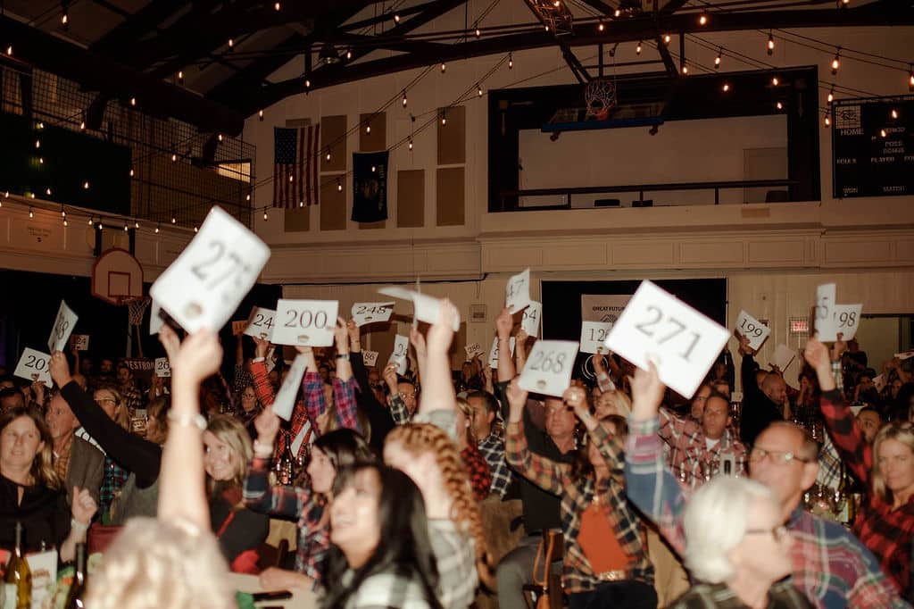 a group of kids holding signs at a school dance